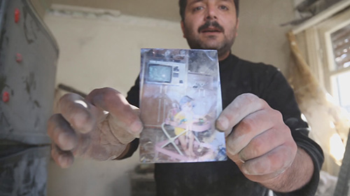 Syria War Documentary Film Man Holding Photo of His Daughter